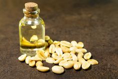 a glass bottle filled with almonds on top of a table