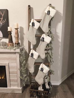 stockings hanging from a ladder in front of a fireplace