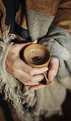 a person holding a cup in their hands