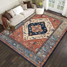 a living room filled with furniture and a large rug