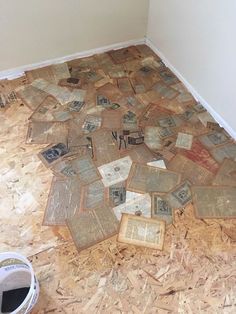 the floor is covered with old books and magazines in this room that needs to be remodeled