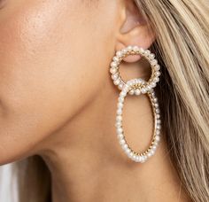 Discover the epitome of elegance with our Gold Double Drop Hoop Pearl Earrings. These luxurious earrings feature two delicately intertwined gold hoops, creating a cascading double-drop design that exudes sophistication and charm. At the heart of each earring lies a lustrous pearl, suspended gracefully within the hoops, adding a timeless touch of refinement. The warm, golden glow of the hoops beautifully complements the iridescent sheen of the pearls, making these earrings a perfect blend of clas Hoop Pearl Earrings, Luxurious Earrings, Jewelry Boutique, Luxury Earrings, Drop Design, Gold Pearl Earrings, Golden Glow, Earring Sale, Drops Design