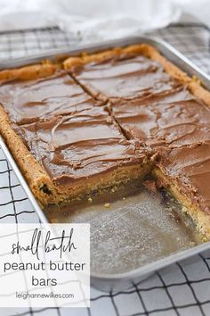 a close up of a cake in a pan with chocolate frosting on the top