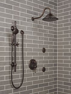 a shower head with thermostaer and faucet in front of it