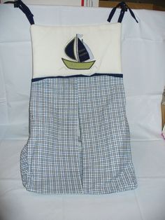 a blue and white checkered bag with a sailboat on it