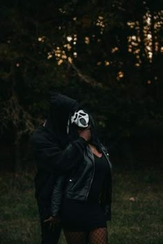 a woman in a black jacket and white mask