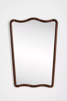 a wooden mirror hanging on the wall