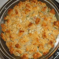 a casserole dish with chicken and cheese in it sitting on a stove top