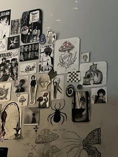 a wall covered in pictures and magnets next to a laptop