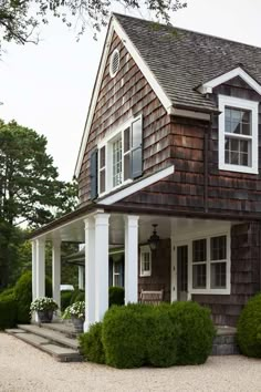 a brown house with white trim and windows