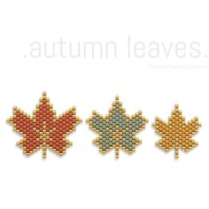 three cross stitched maple leaf magnets in different colors and sizes on a white background