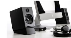 two computer monitors sitting on top of a white desk next to a keyboard and mouse