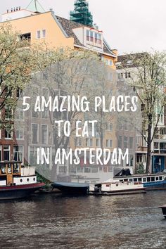 some boats are sitting on the water in front of buildings and trees with text overlay that reads, 5 amazing places to eat in amsterdam