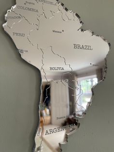 a mirror that is reflecting the map of brazil