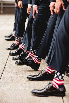 a row of men in suits with american socks