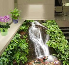 the floor is covered in plants and rocks, with a waterfall running down it's side