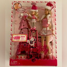 two barbie dolls in pink and white outfits with christmas decorations on the top of their heads