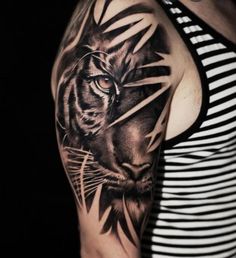 a black and white photo of a tiger on the arm, done by tattoo artist person