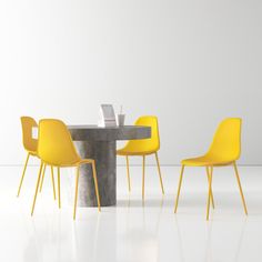 three yellow chairs sitting at a table with a white wall in the backround