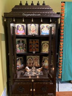 an ornate wooden cabinet with pictures on it