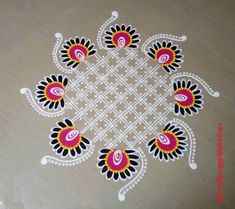 an intricate design on the floor in white and pink colors with black, yellow and red accents