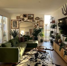 a living room filled with furniture and lots of plants