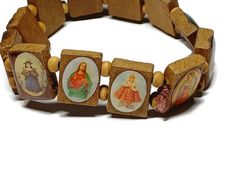 This bracelet measures 8 inches long by .5 inches wide. There are portraits of various representations of Mary, Jesus, and the Holy Family. Jesus Bracelet, Shell Beads Necklace, Sparkly Necklace, The Holy Family, Wood Bead Bracelet, Prayer Box, Puka Shell, Holy Family, Necklace Box