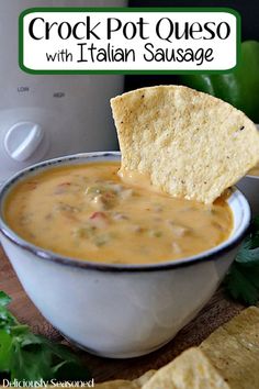 a bowl of crock pot queso with italian sausage and tortilla chips