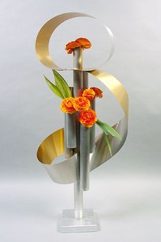 there is a vase with orange flowers in it