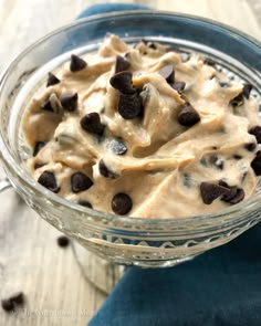 a glass bowl filled with cookie dough and chocolate chips