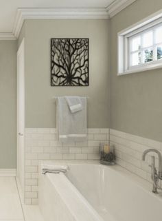 a large bathroom with white tile floors and walls, along with a bathtub in the center