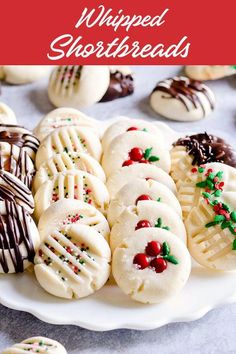 christmas shortbreads on a white plate with chocolate drizzle and sprinkles