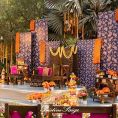 an outdoor wedding setup with purple and orange decor