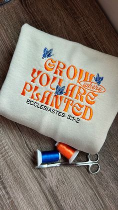 the embroidered pouch has scissors and thread on it