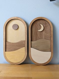 two wooden trays sitting on top of a table