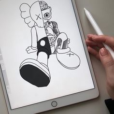 a person holding an ipad with a drawing on the screen and a pen next to it