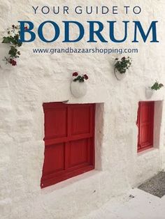 two red shutters on the side of a white building