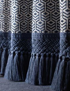 black and white wall hangings with tassels on them