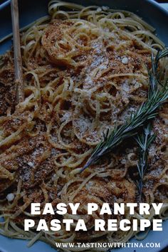 the pasta dish is ready to be eaten with rosemary garnish on top and served in a blue bowl