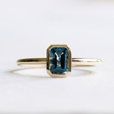 Emerald cut London blue topaz set on 14k yellow gold Metal: 14k Yellow Gold Stone: London Topaz Stone Size: 6mm x 4mm Stone Shape: Emerald cut Band Width: Approx. 1.5mm LEAD TIME: Made to order will take 10-14 days Modern 14k Gold Emerald Cut Topaz Ring, Emerald-cut Topaz Birthstone Ring In Yellow Gold, Emerald Cut Yellow Gold Topaz Birthstone Ring, Emerald Cut Band, Engagement Ring Alternative, London Blue Topaz Engagement Rings, London Topaz Ring, London Topaz, Emerald Cut Ring