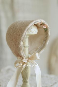 a white hat with flowers on it sitting on top of a table