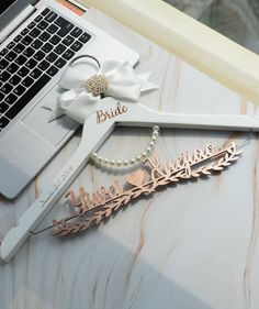 the bride's hair comb and pearl necklace are laying next to a laptop