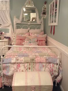 a bedroom with a bed, dresser and mirror on the wall next to it is decorated in pastel colors