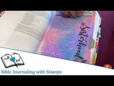 an open book with the words bible journaling with stamps written on it and someone holding a pen in their hand