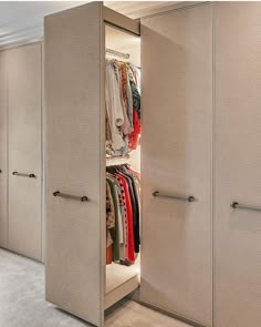 an open closet with clothes on hangers