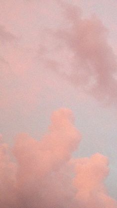 the plane is flying high in the sky with pink clouds behind it and an airplane on top