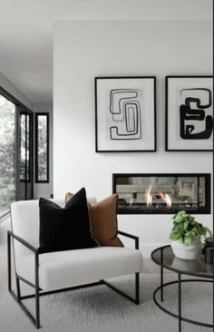 a living room filled with furniture and pictures on the wall above it's fireplace