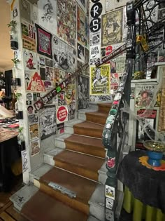 there are many pictures on the wall and stairs in this room that is decorated with stickers