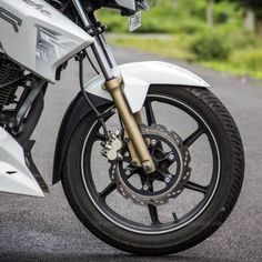 a white motorcycle is parked on the street