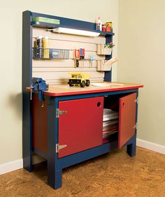 a red and blue workbench sitting in the corner of a room